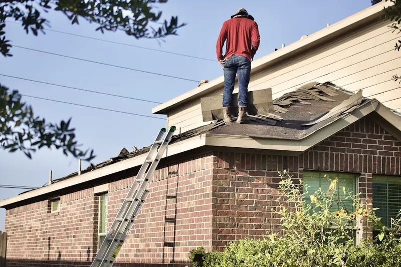 Professional roofer working on a residential roof in Cedar Rapids